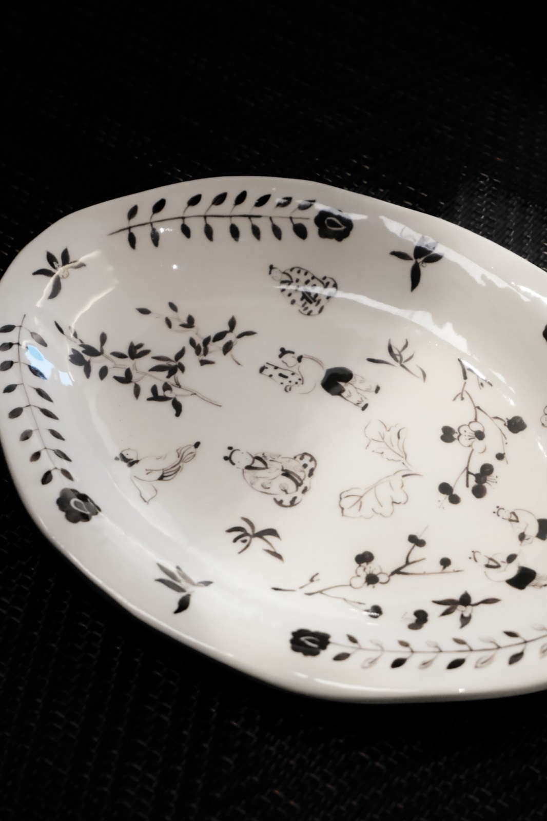 Antique patterned plate against a dark background
