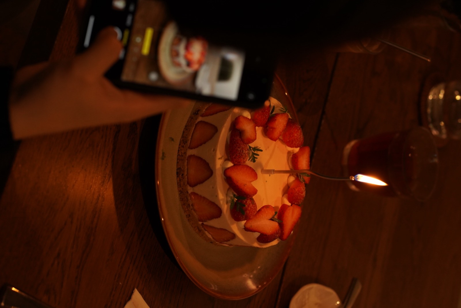 A small candle flame at a celebration table