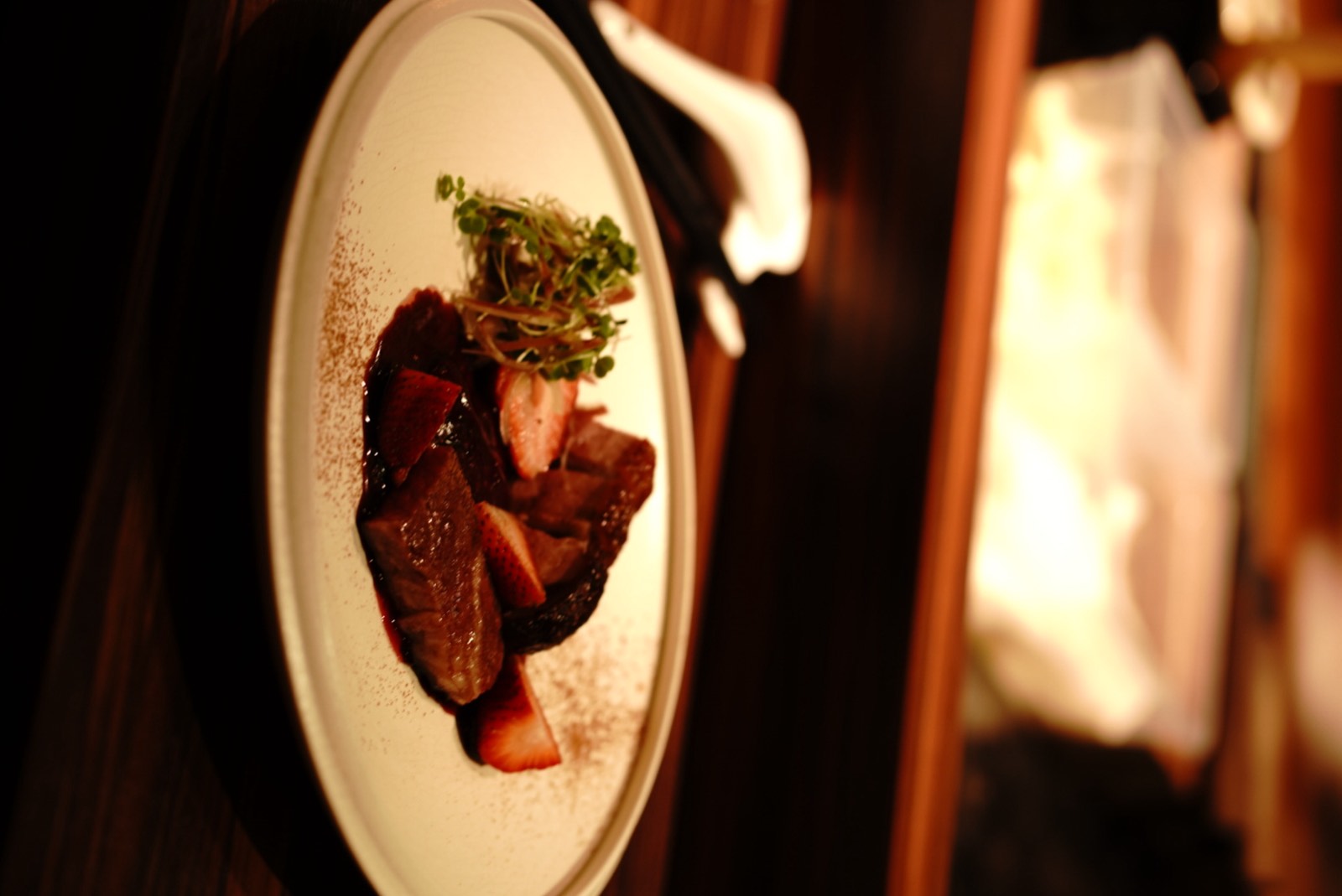 A plated dinner in warm restaurant light